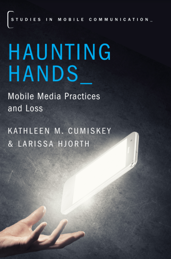 Book cover for Haunting Hands, a glowing mobile phone screen floats above an open hand